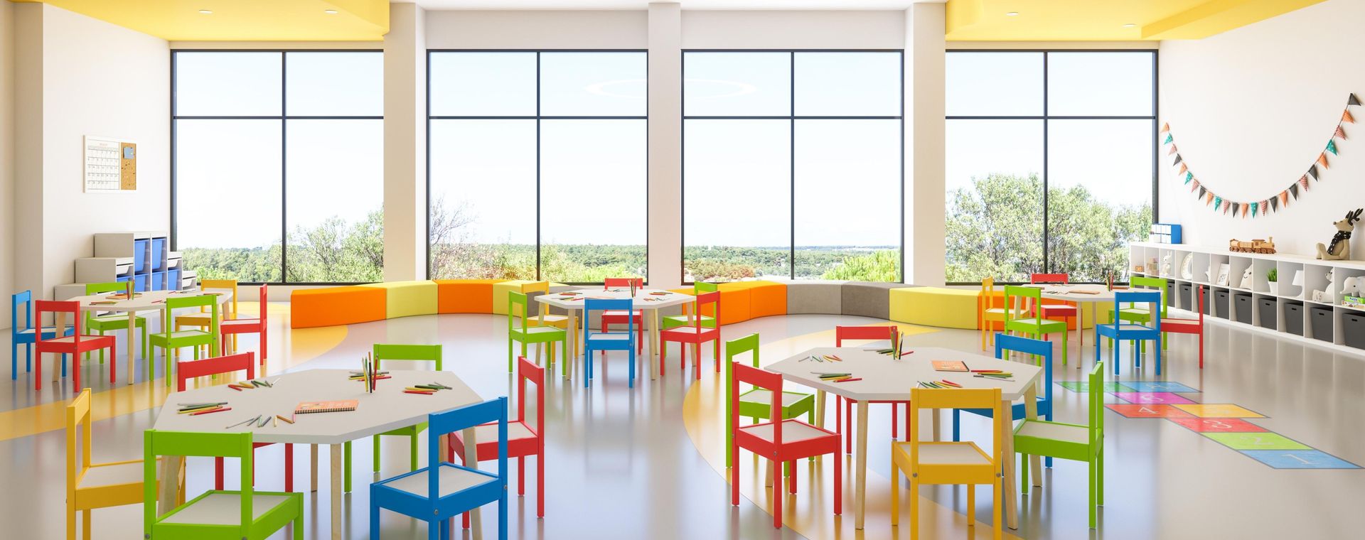 Spacious bright classroom with colourful kids' tables and chairs
